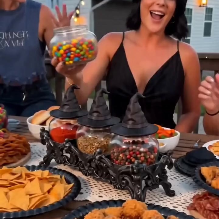 One jar lifted individually out of the connected stand, filled with candy, while the other two jars hold spices
