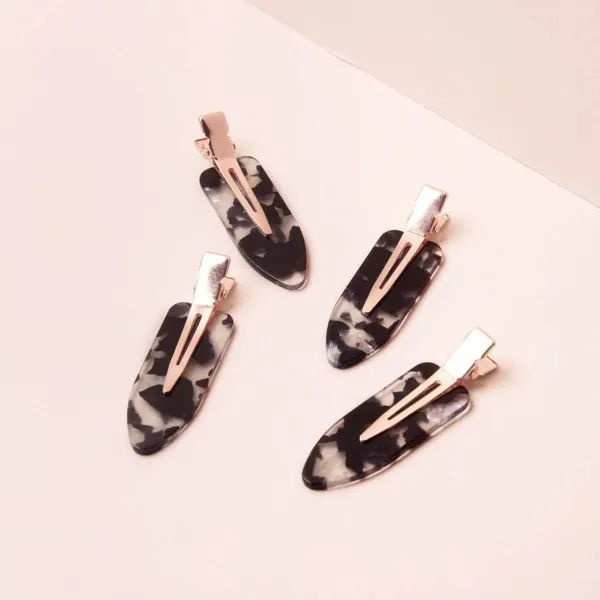 A Set Of Four Universal Black And White Striped Hair Clips For Fashion Use