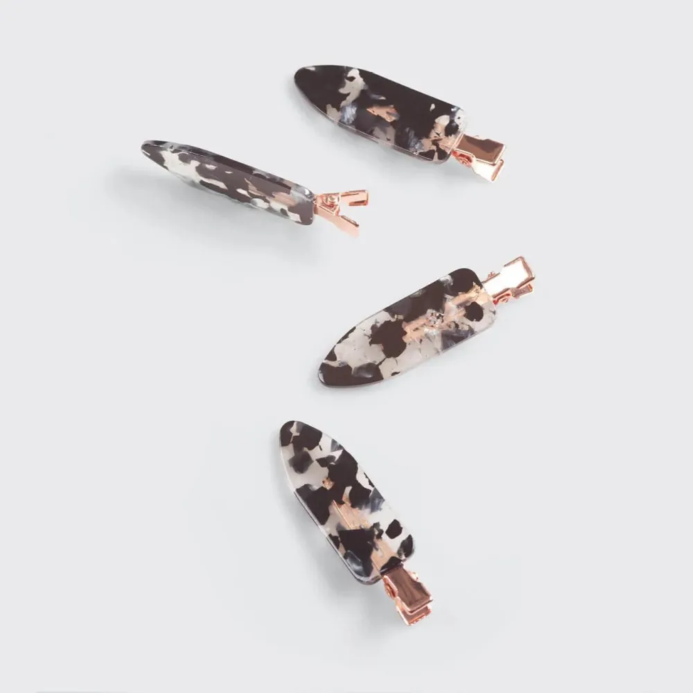 A Set Of Four Universal Black And White Striped Hair Clips For Fashion Use